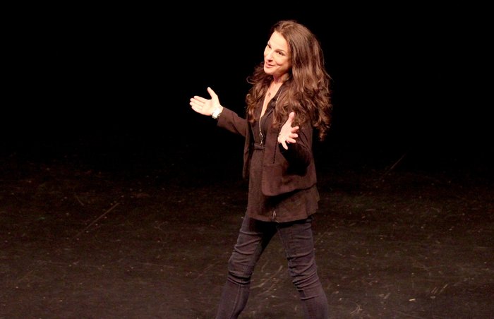Emily Brandwin performing improv comedy on stage